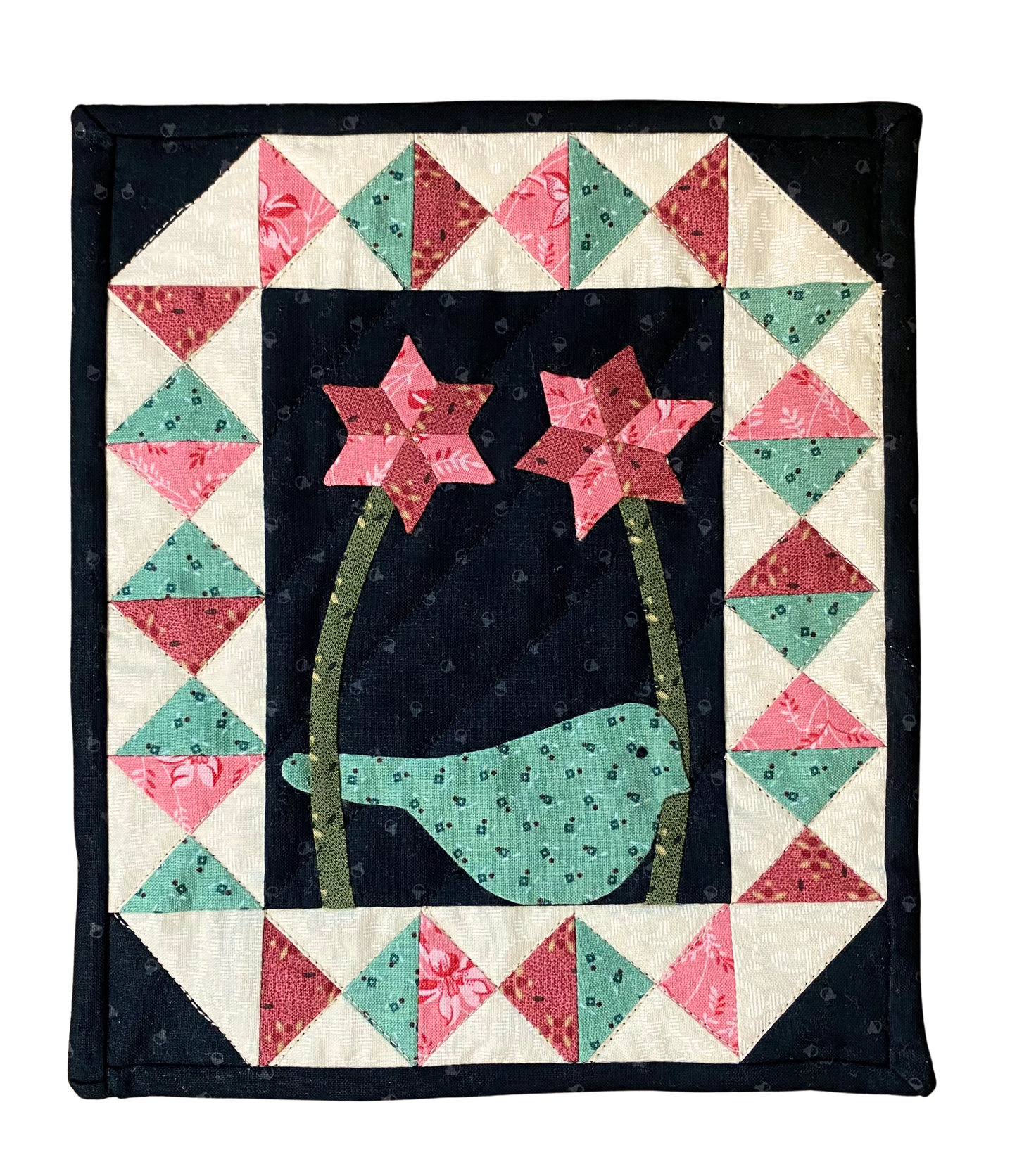 Quilt with a bird and flowers design on a black background