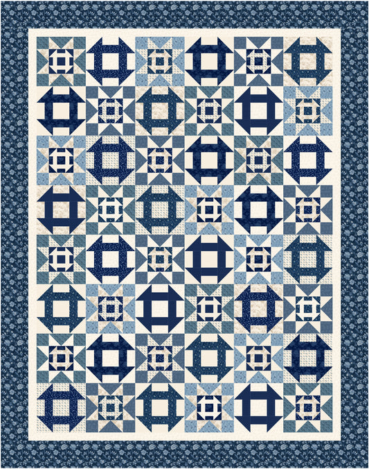 Quilt with blue and white geometric pattern on a blue background