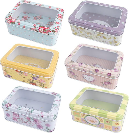 6 Tin floral colored boxes with clear window in cover on a white background.