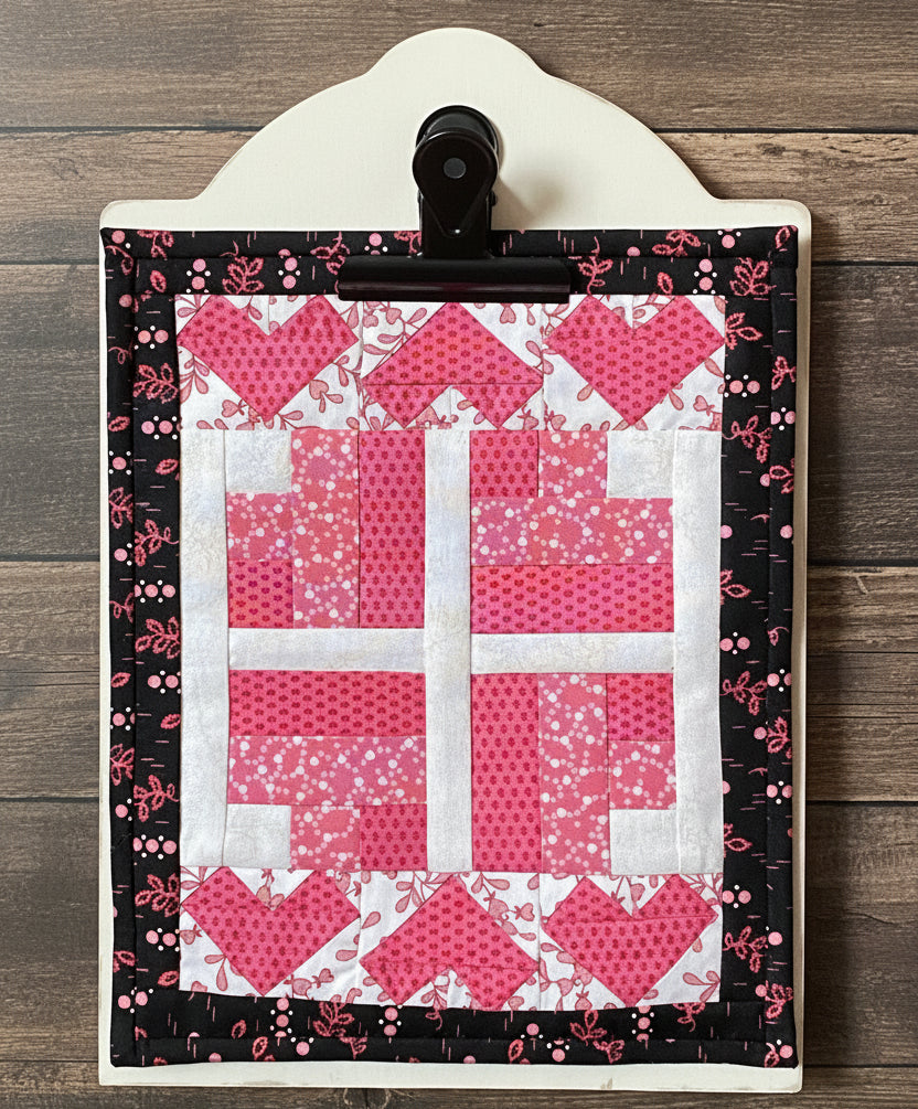 Quilted heart pattern on a white background with a black border