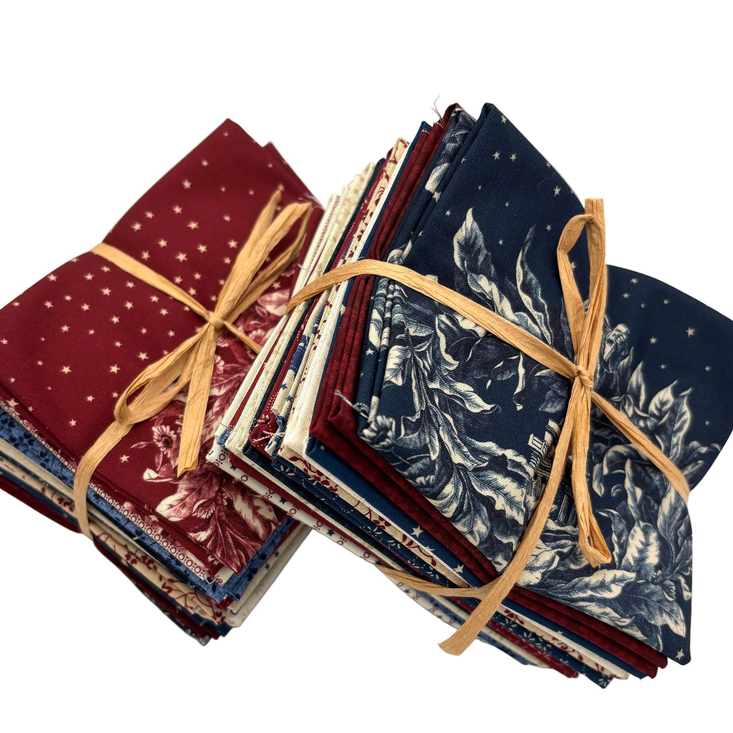 Stack of fabric bundles featuring red, white and blue patriotic fabrics.