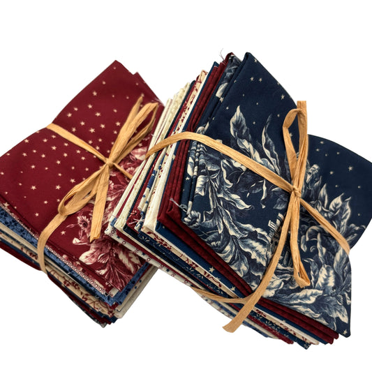 Stack of fabric bundles featuring red, white and blue patriotic fabrics.