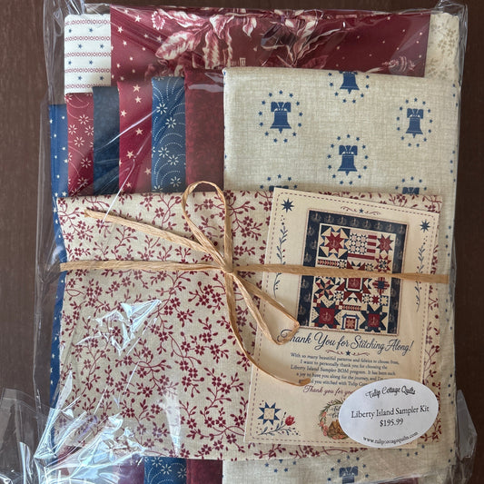 A packaged fabric bundle wrapped in clear plastic and tied with twine on a dark wooden surface.