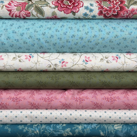 Stack of floral fabric swatches in various pink, blue, white and green colors