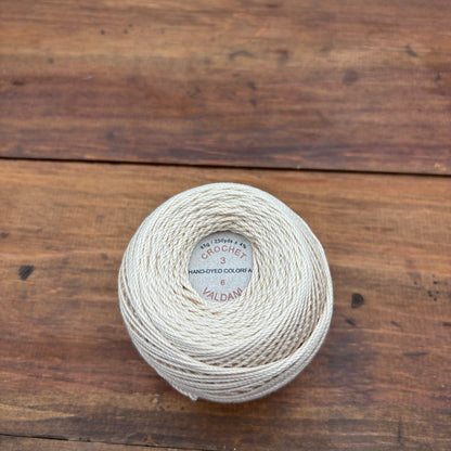 Ball of yarn with a label on a wooden surface