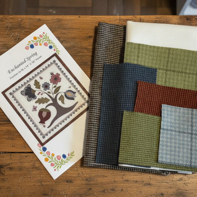 Fabric swatches and a pattern book on a wooden surface