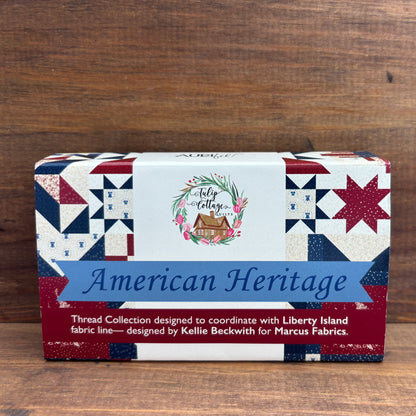 Box of 'American Heritage' thread collection with patterned design on a wooden background