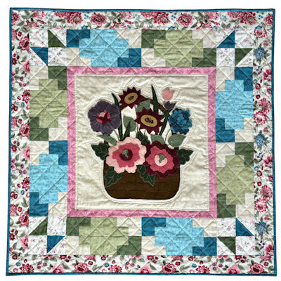 Quilt with floral design and block pattern