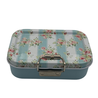 Rectangular tin box with floral and striped design on a white background