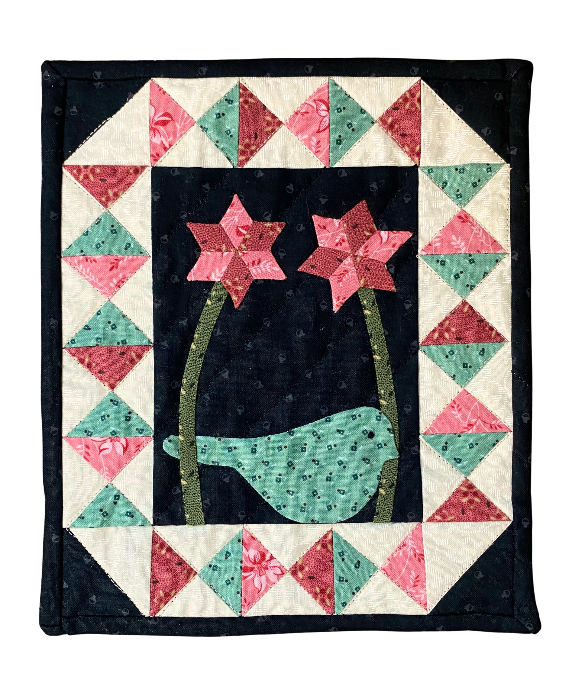 Quilt with a bird and flowers design on a black background