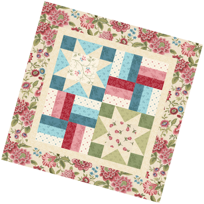 Pillow/table topper quilt with star and rail fence patterns and floral borders on a white background