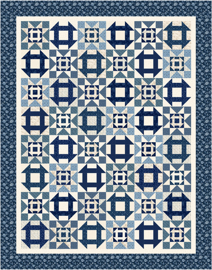 Quilt with blue and white geometric pattern on a blue background
