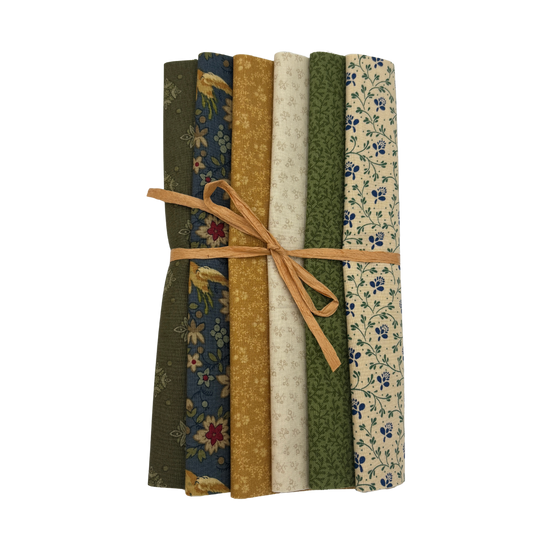 A bundle of six patterned fabric rolls tied together with a tan string, displayed against a solid white background.