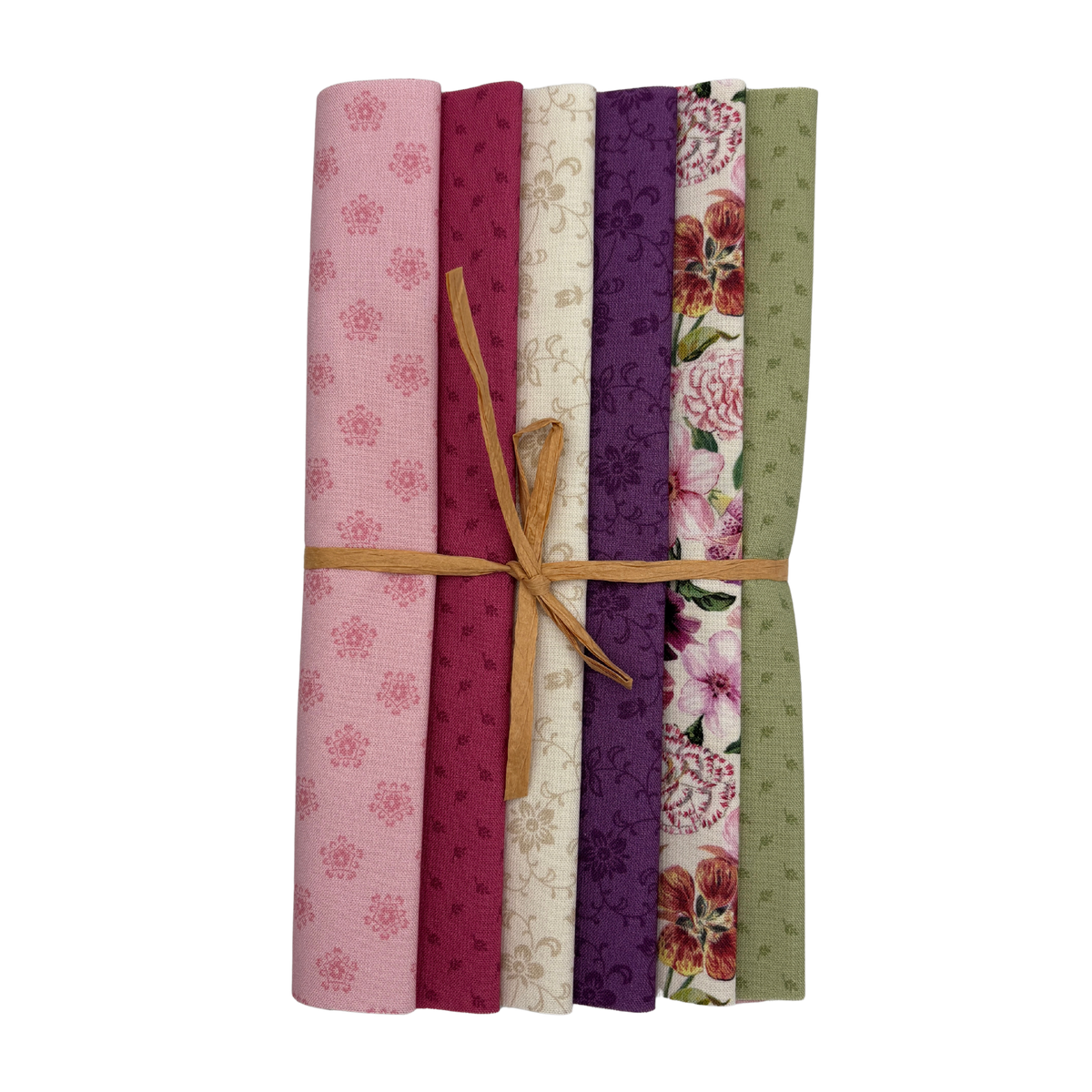 A bundle of six folded fabric swatches tied with a tan string, showing assorted floral and patterned designs in pink, burgundy, cream, purple, red, and sage green on a white background.