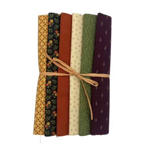 A bundle of six patterned fabric slices tied together with a natural twine string, displayed on a clean white background.