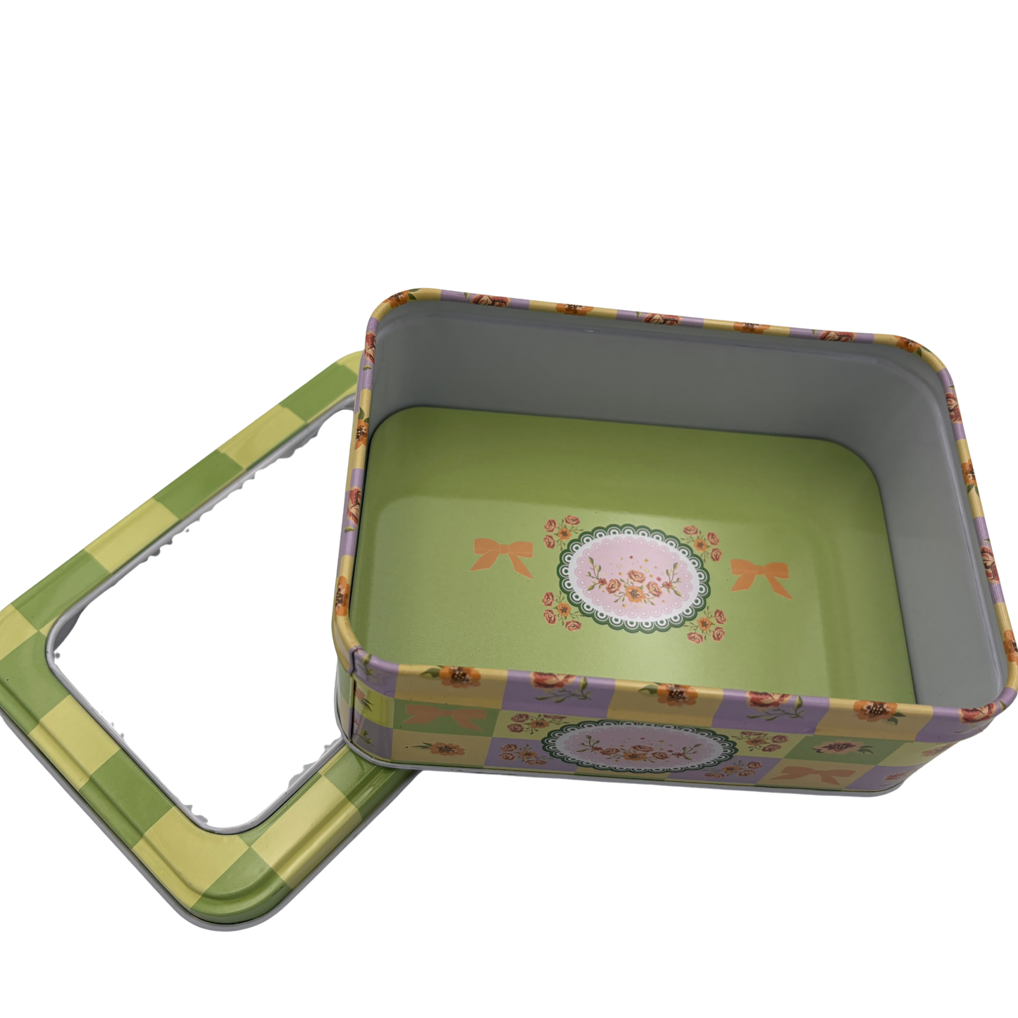 Floral-patterned metal tin with lid on a white background