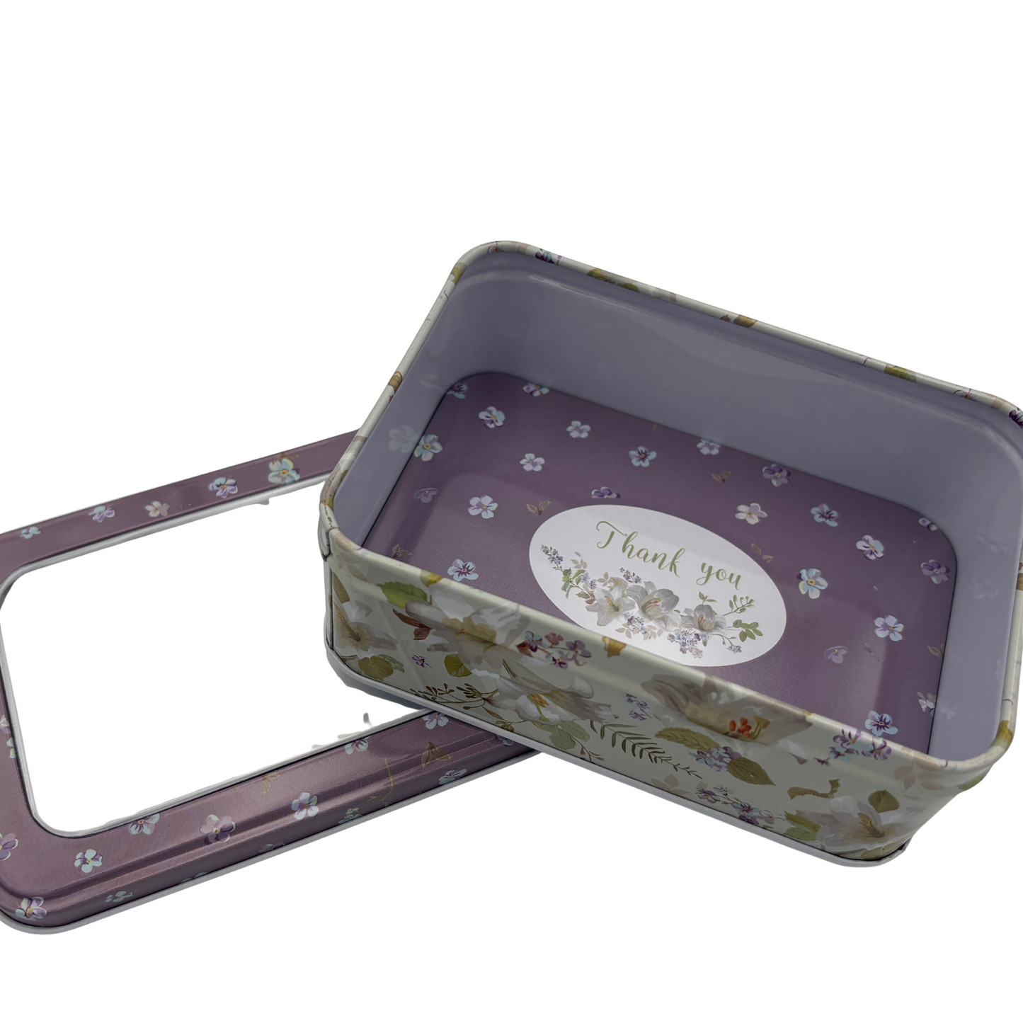 Floral-patterned metal tin with lid on a white background