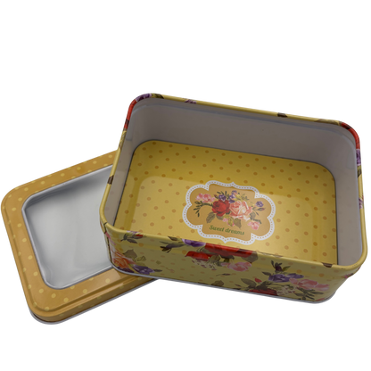 Floral-patterned metal tin with lid on a white background