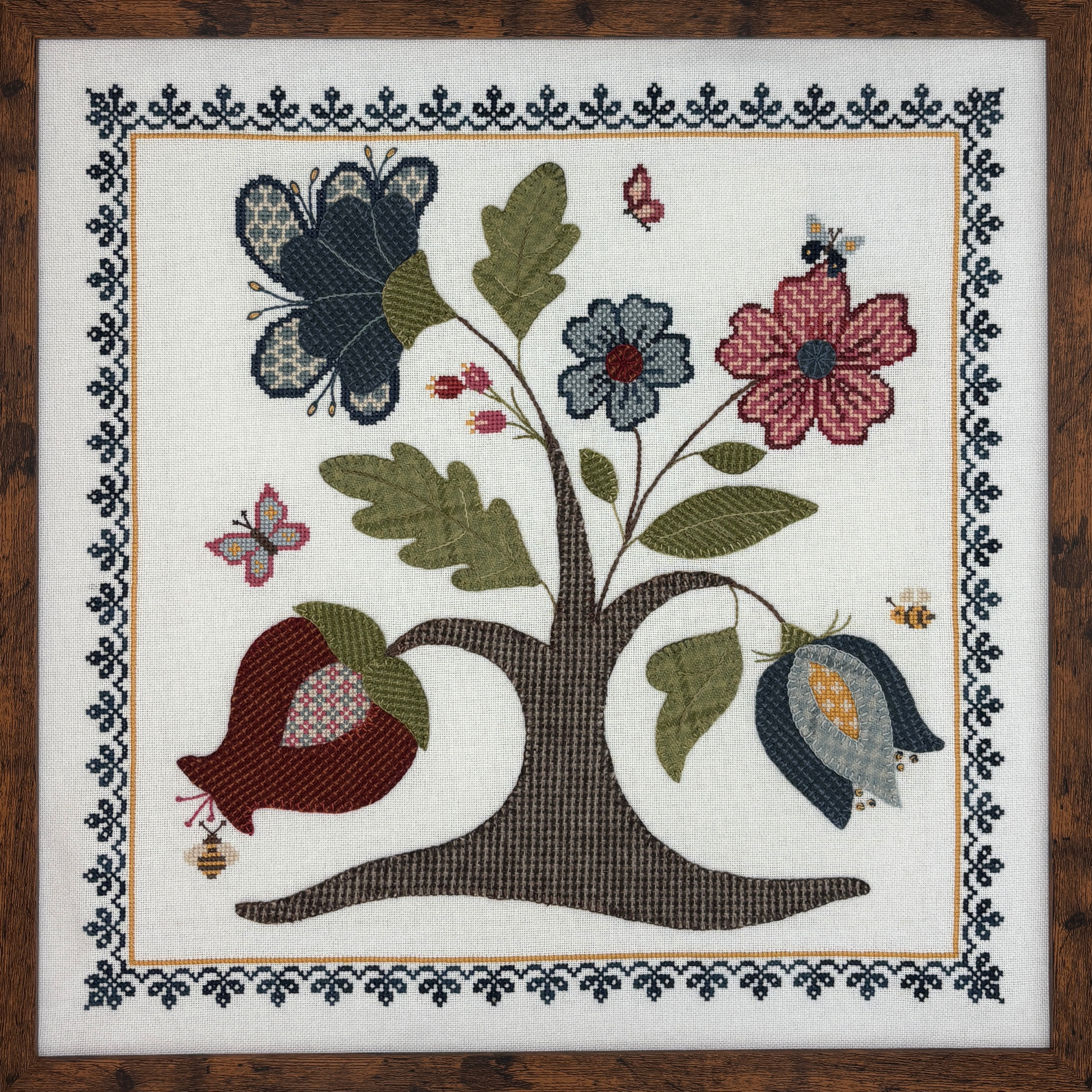 cross stitch and wool applique design of a tree with flowers, butterflies, and bees on a white background.