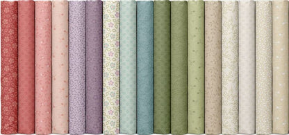 Fabric bolts showing the fabrics in the Karoline's Garden fabric collection by Marcus Fabric. Colors range from red to pink, purples, blues, greens and creams.