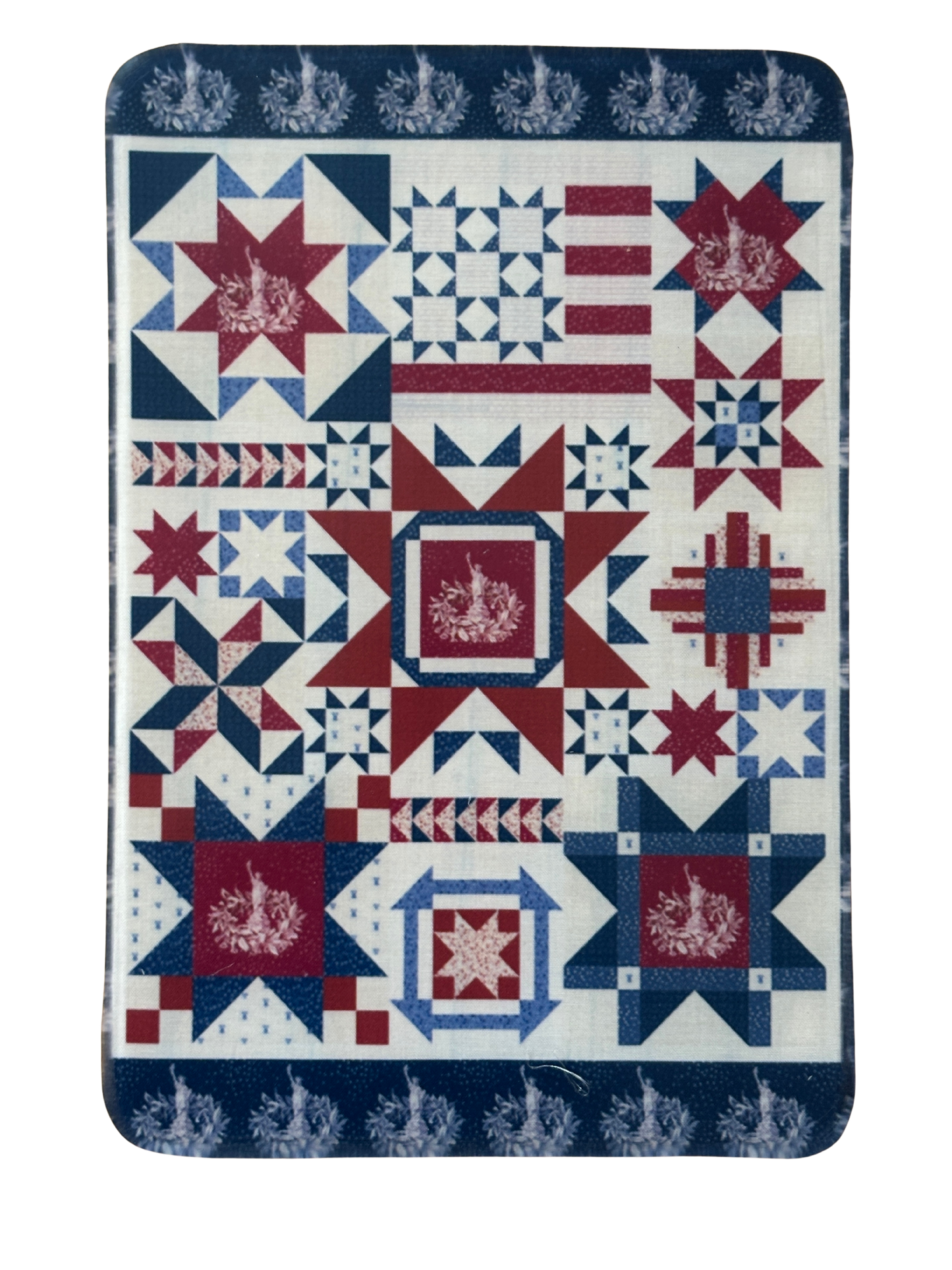 Quilt with red, white, and blue geometric pattern on a white background