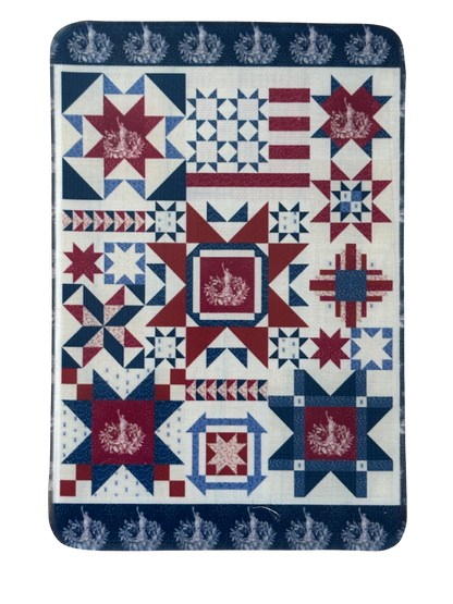 Quilt with red, white, and blue geometric pattern on a white background