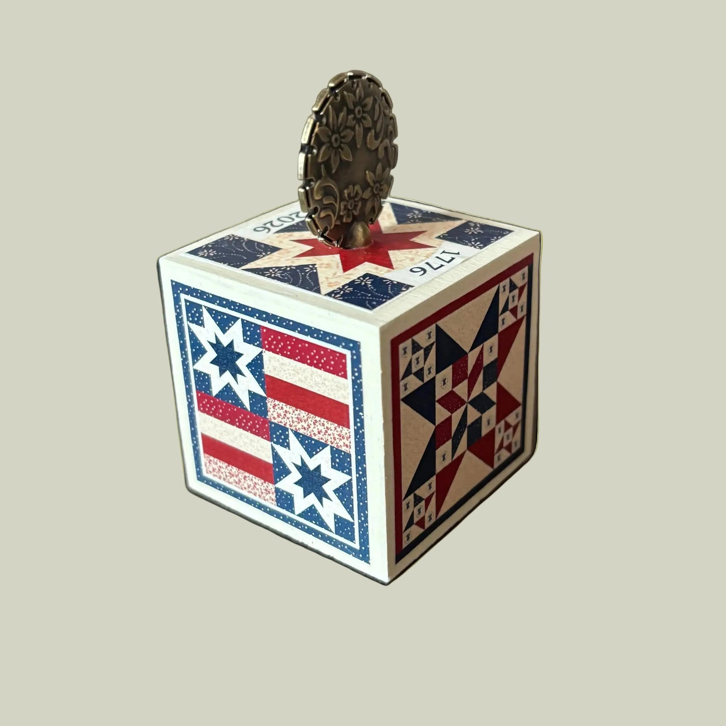 Wooden cube with American flag design on a white background.