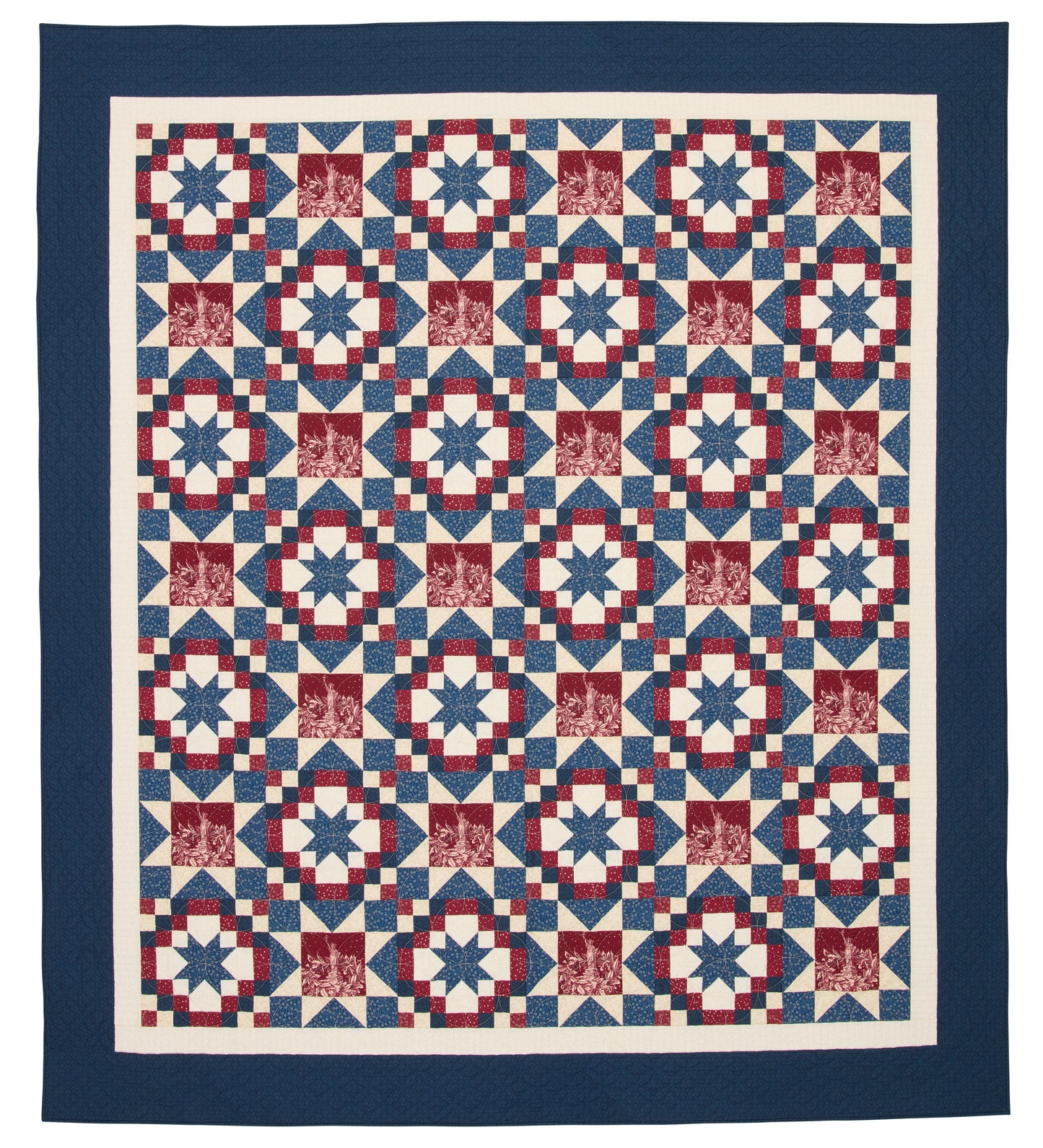 Quilt with a geometric pattern in red, white, and blue on a white background