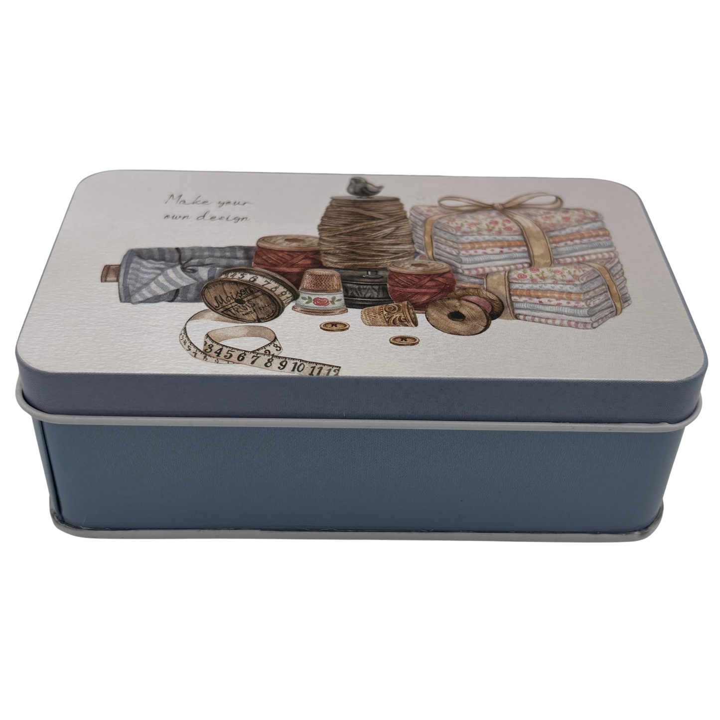 Decorative tin box with sewing-themed design on a white background