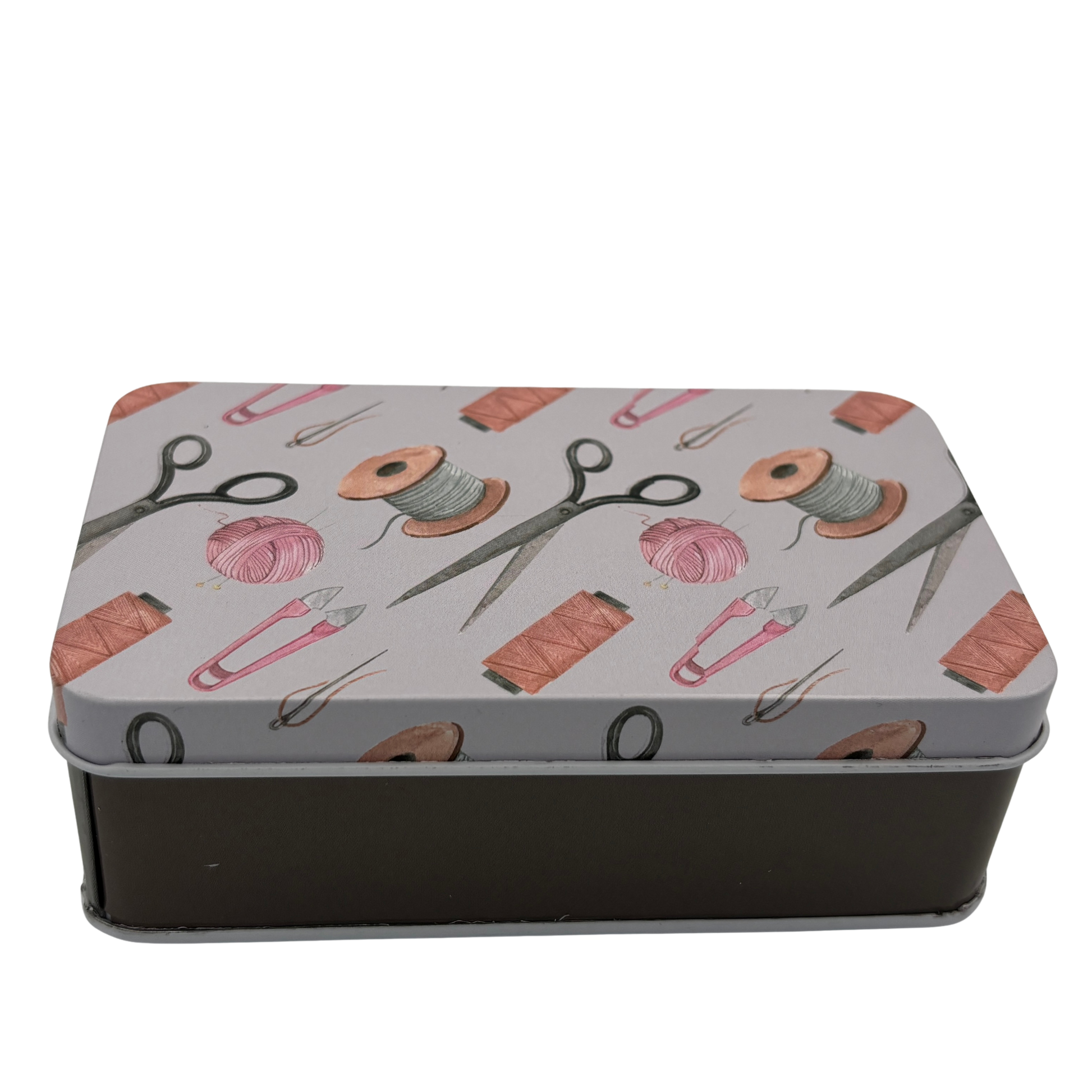 Metallic tin with sewing-themed design on a white background