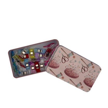 Sewing kit in a decorative tin with sewing-themed design on a white background