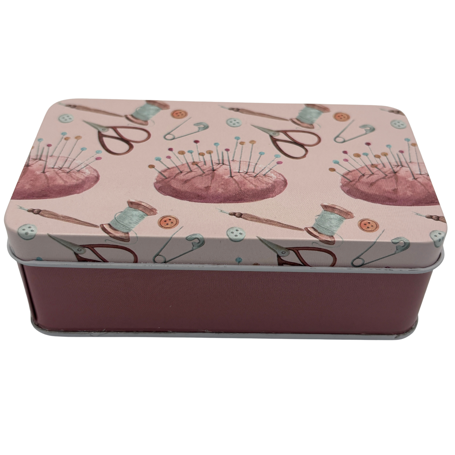 Rectangular tin box with sewing-themed design on a white background