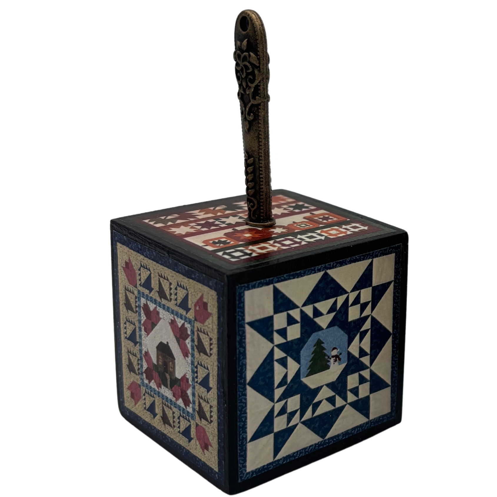 Decorative box with quilt pattern and seam ripper on a white background