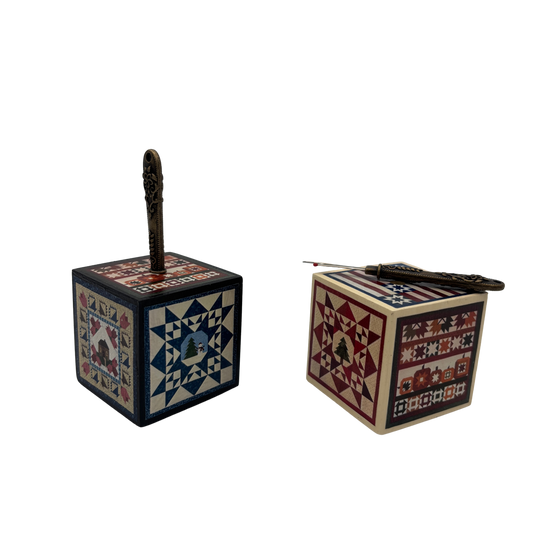 Two wooden boxes with decorative quilt patterns on a white background