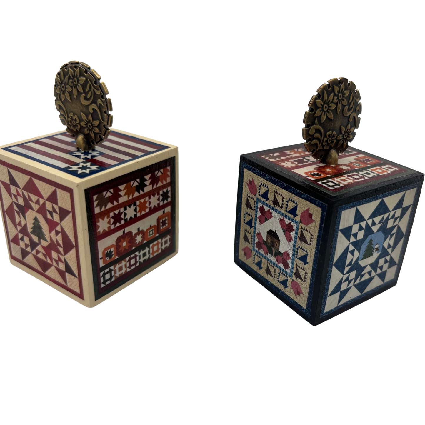 Two decorative wooden cubes with quilt-style patterns on a white background