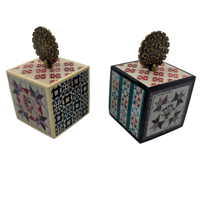 Two decorative wooden cubes with intricate patterns on a white background