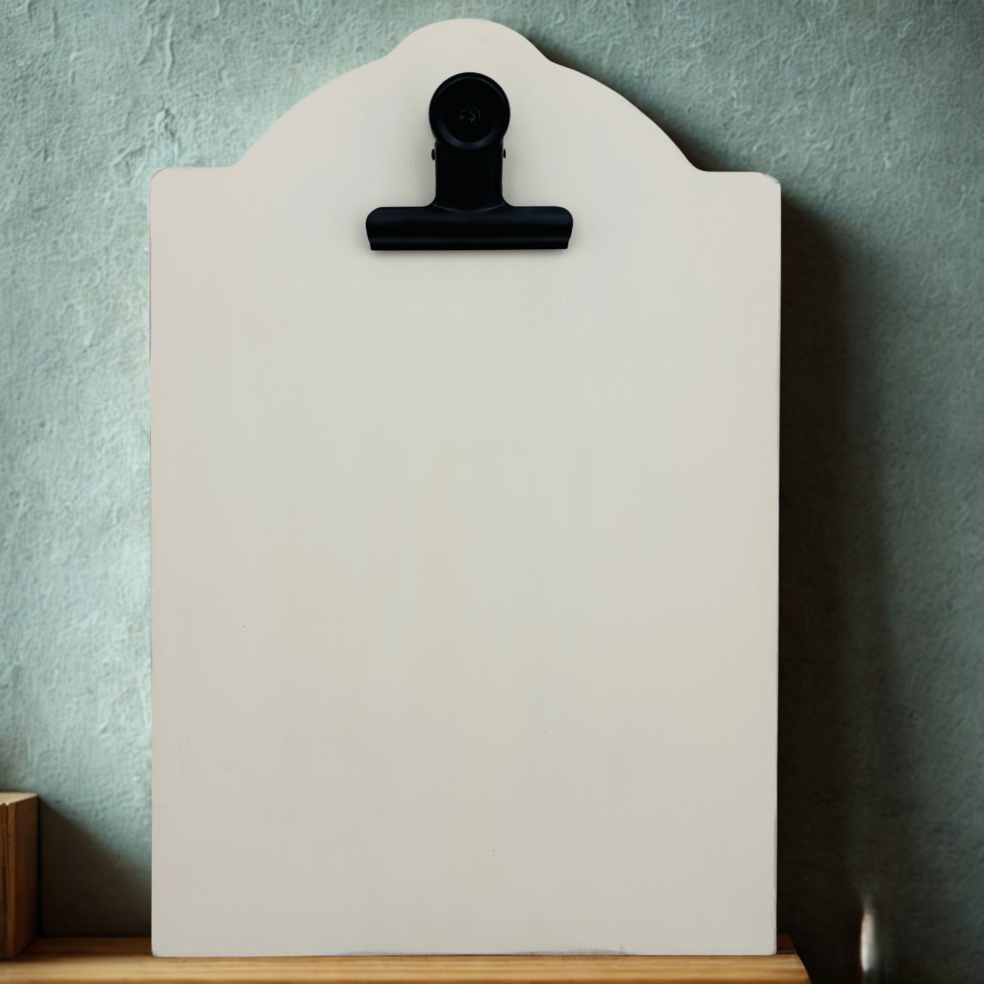 White clipboard leaning against a blue wall