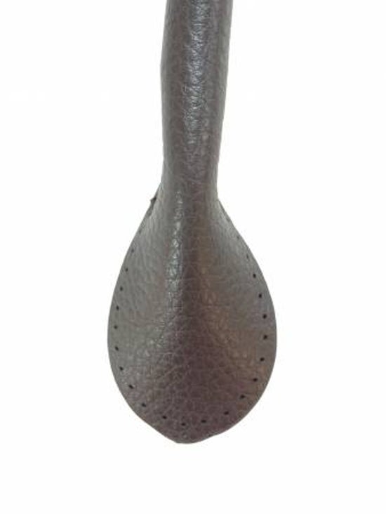 Close-up of a faux leather bag handle on a white background