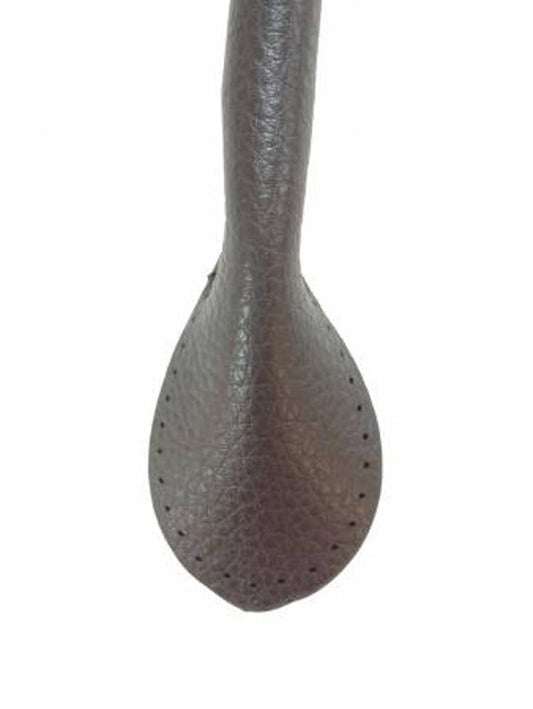 Close-up of a faux leather bag handle on a white background