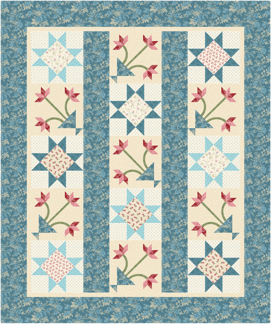 Quilt with floral and star patterns on a blue background
