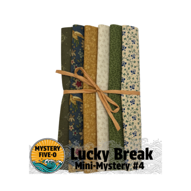 Set of fabric bundles tied with a ribbon, labeled 'Lucky Break Mini-Mystery #4' from Mystery Five-O.