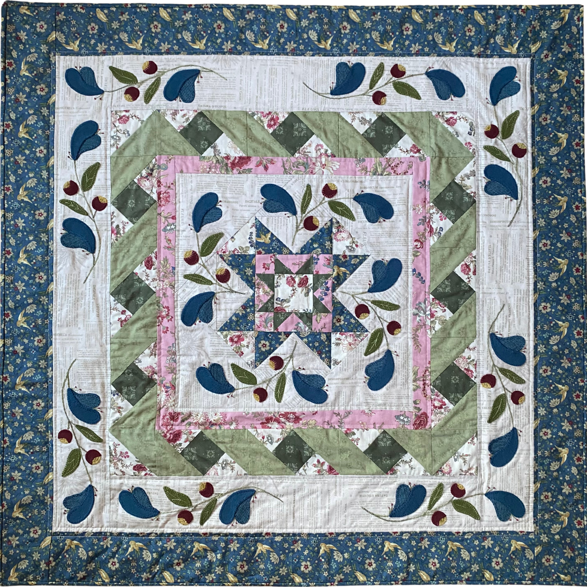 Quilt with floral and leaf patterns on a blue background
